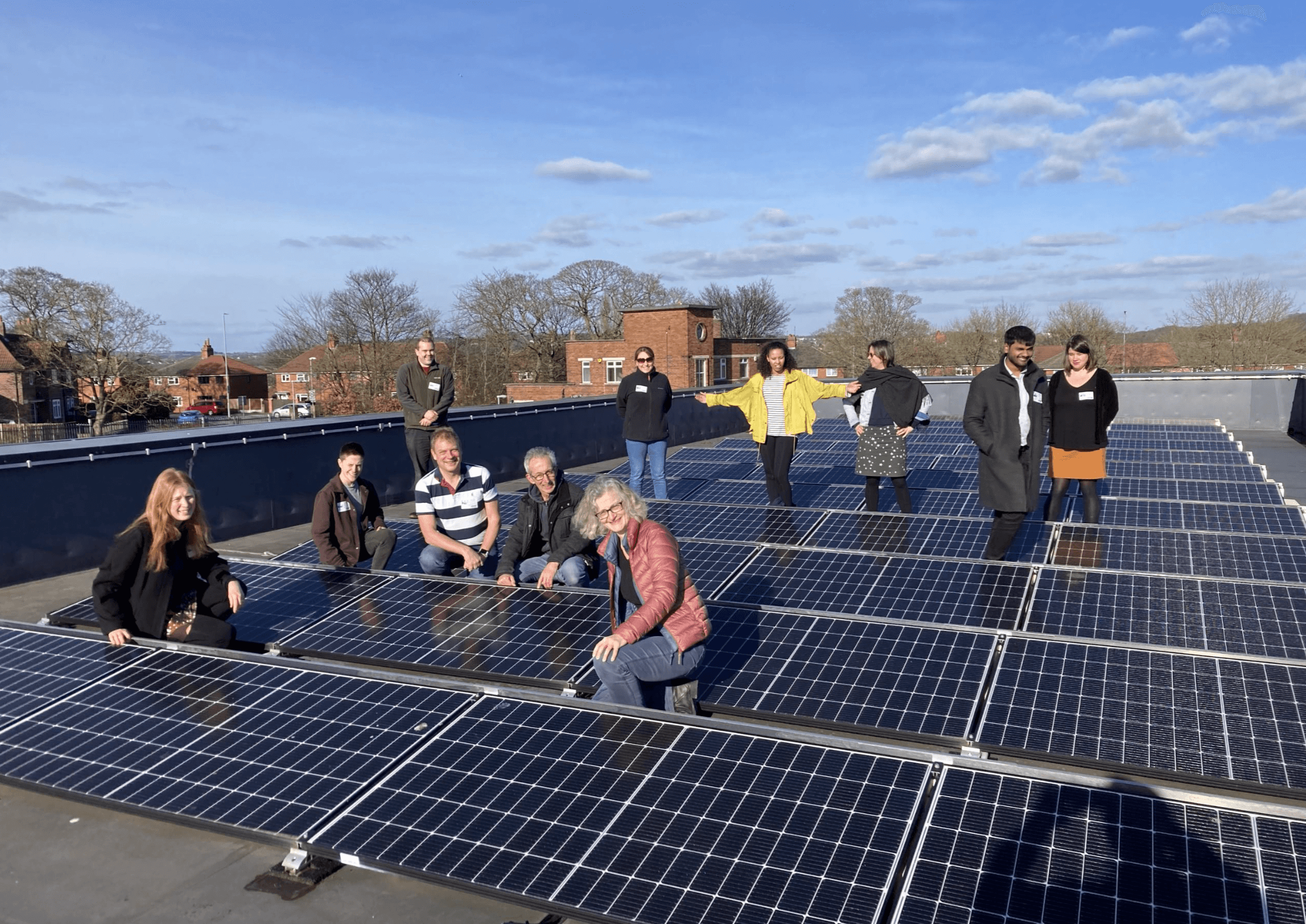SfS team on roof with solar panels